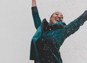 woman jumping for joy with confetti
