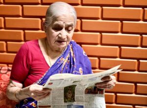 elderly woman reading the paper